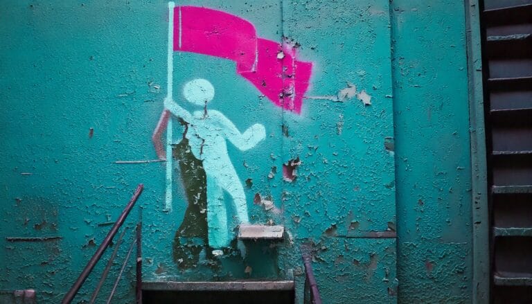 Person planting a flag at top
