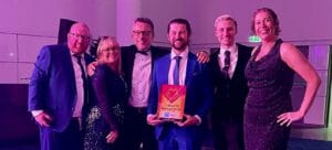 UK Customer Experience Awards 2026 Gold trophy held by the Bupa and Elev-8 team.