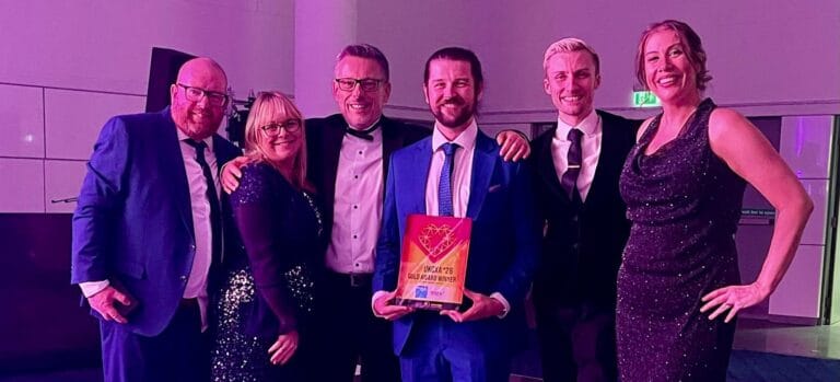 UK Customer Experience Awards 2026 Gold trophy held by the Bupa and Elev-8 team.